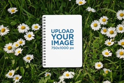 Mockup of an AI-Generated Spiral Journal Lying on a Daisy Garden m53841