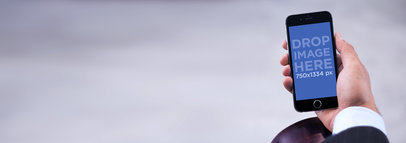 Stock Photo of a Businessman Holding a Black iPhone 6 on Leather Armrest