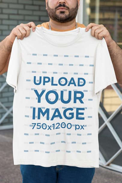 Bella Canvas Mockup Featuring a Bearded Cropped-Face Man Holding a Round-Neck T-Shirt