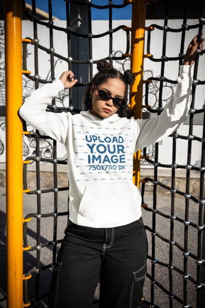 Comfort Colors Hoodie Mockup of a Woman Posing on a Playground's Game m53352