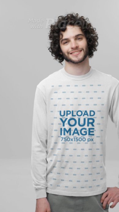 Video of a Happy Curly-Haired Man Wearing a Long-Sleeve Tee by Comfort Colors in a Studio