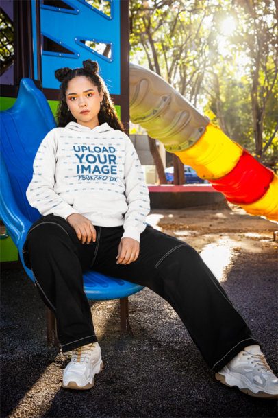 Comfort Colors Pullover Hoodie Mockup Featuring a Woman Sitting on a Playground Slide m53355