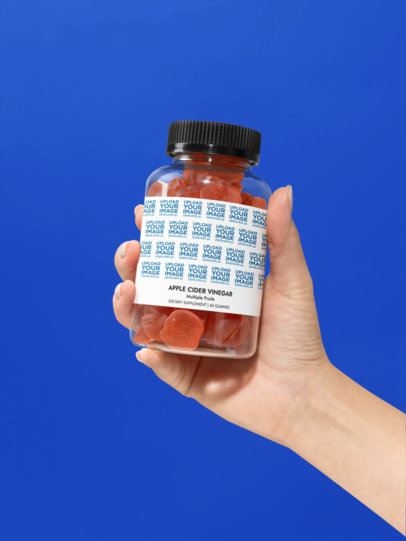 Apple Cider Vinegar Gummies Supplement Mockup Featuring a Hand Against a Colorful Wall m53575