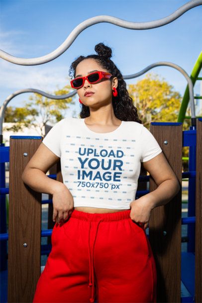 Bella Canvas Crop Top Mockup of a Cool Woman Posing in a Playground m53361