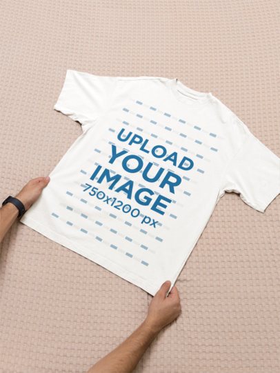 Oversized Round-Neck T-Shirt Mockup Featuring a Man Putting a Garment in a Soft Surface m52022