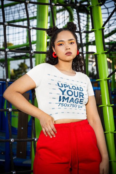 Bella Canvas Crop Top Mockup Featuring a Woman With Curly Hair Posing in a Playground m53363
