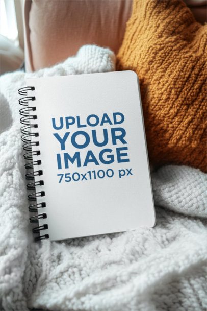 Mockup of an AI-Generated Spiral Journal Placed on a Cozy and Warm Setting m53832