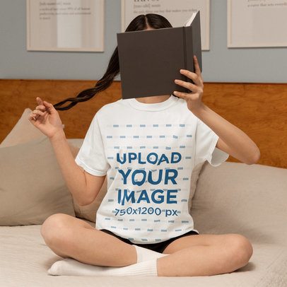 Comfort Colors Tee Mockup of a Woman Covering Her Face With a Book in a Homemade Feel Setting m53788