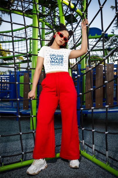 Bella Canvas Crop Top Mockup of a Cool Woman Posing in a Playground Game m53362