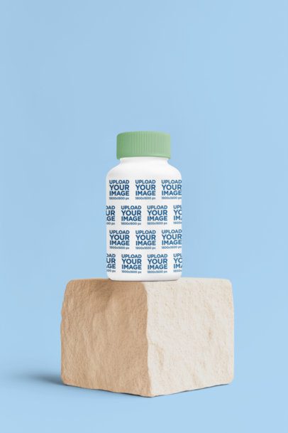 Supplement Mockup Featuring an AI-Created Capsules Bottle Placed on a Rock m53970