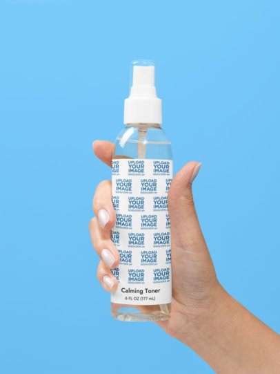 Calming Toner Mockup Featuring a Woman's Hand Against a Customizable Backdrop m53631