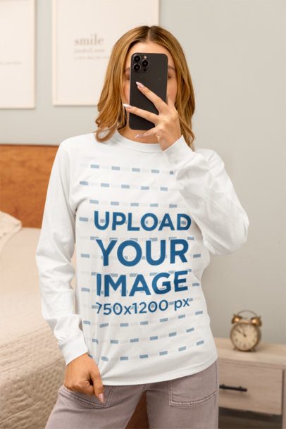 Comfort Colors Long-Sleeve Tee Mockup Featuring a Woman Taking a Selfie in a Homemade Feel Bedroom m53774
