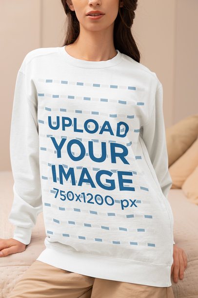 Comfort Colors Mockup Featuring a Cropped-Face Woman in a Sweatshirt Sitting on a Bed m53796