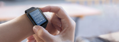 Mockup Template of a Woman Using her Black Apple Watch
