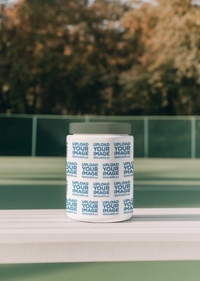 Mockup of an AI-Generated Supplement Wide Mouth Bottle Placed on a Bench in a Sports Court m53972