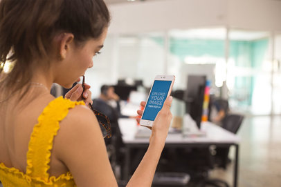 Mockup of a Woman Using a Gold iPhone 8 Plus Holding her Glasses