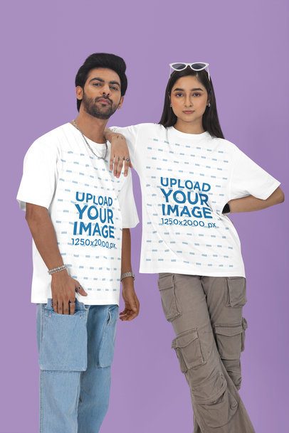 Mockup of a Serious Couple Posing Against a Colorful Background Wearing Oversized T-Shirts