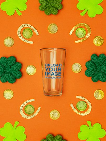 Mockup of a Shaker Pint Glass Lying on a St. Patrick's Day-Themed Background