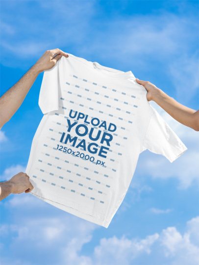 Mockup of Two Persons Holding an Oversized T-Shirt Against the Sky