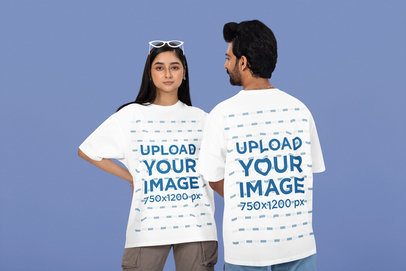 Oversized T-Shirt Mockup Featuring a Serious Couple Standing Against a Colorful Background
