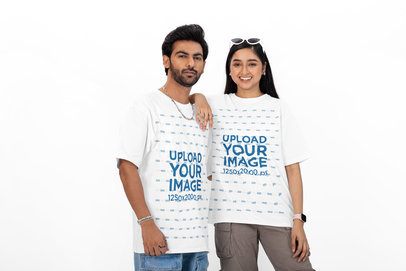 Oversized T-Shirt Mockup Featuring a Happy Woman Posing With a Bearded Man in a Studio
