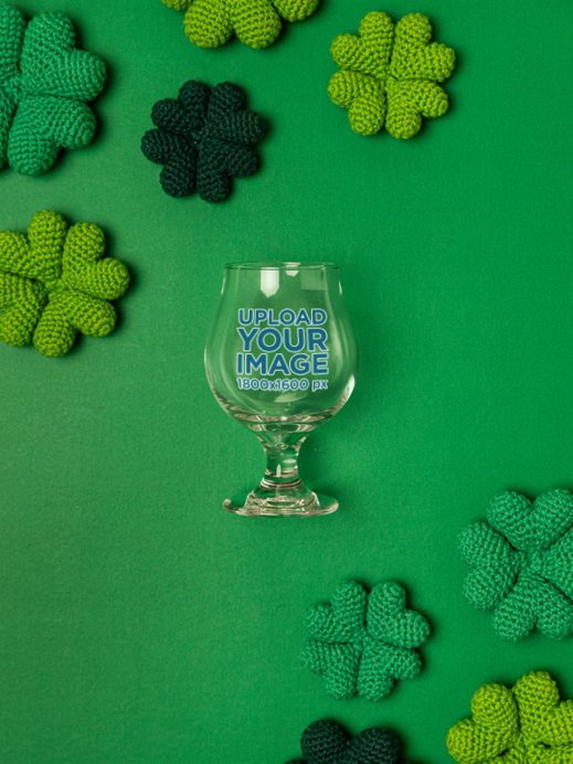 Drinkware Mockup Featuring a Tulip Glass Placed on a Surface With St. Patrick's Day Decorations
