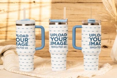 Stanley Mockup Featuring Three Tumblers Placed in a Cozy Setting m54056