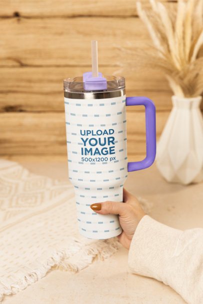 Drinkware Mockup Featuring a Woman Holding a Stanley Tumbler in a Cozy Room m54055