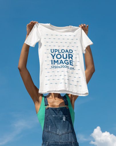 Sky Shot Mockup Featuring a Woman Holding a Bella Canvas T-Shirt m51757