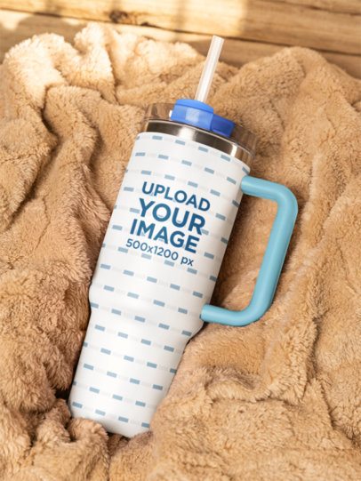Mockup of a Stanley Tumbler Lying on a Cozy Blanket m54058