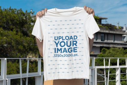 Mockup of a Man Covering His Face With a Bella Canvas T-Shirt