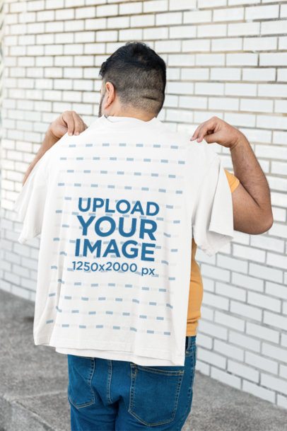 Mockup of a Man Putting an Oversized T-Shirt on His Back