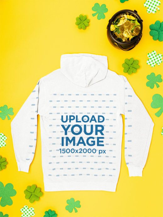 Comfort Colors Mockup Featuring a Hoodie With Customizable Sleeves Lying on a St. Patrick's Day Background