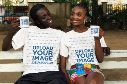 Round-Neck T-Shirt Mockup Featuring a Happy Man and Woman Sitting on a Bench With Coffee Mugs
