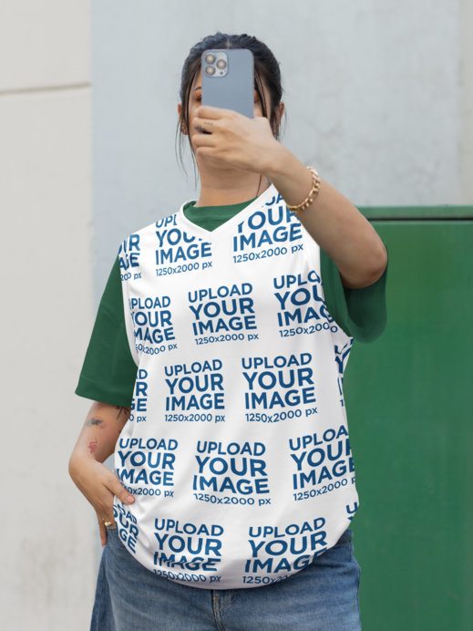 Basketball Jersey Mockup Featuring a Tattooed Woman Taking a Selfie in the Street