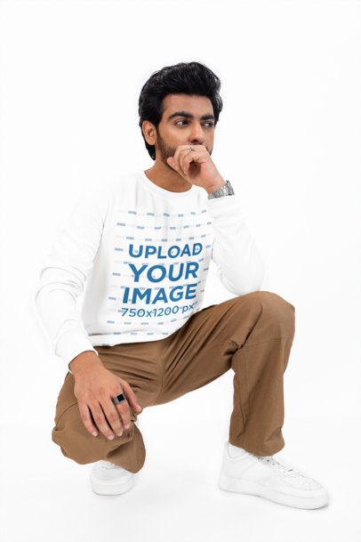 Bella Canvas Long-Sleeve Tee Mockup of a Man Crouching in a Studio m53073