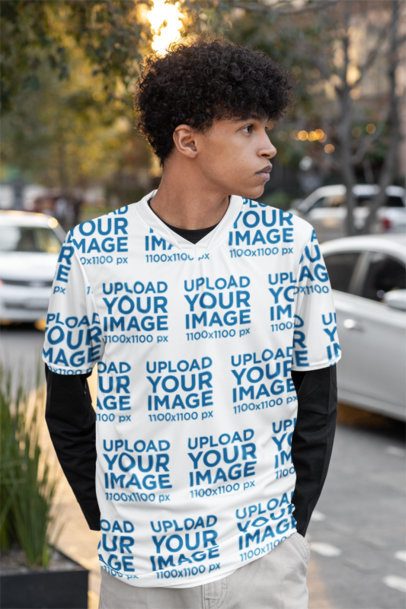Sports Jersey Mockup Featuring a Curly-Haired Man With a Serious Look Standing in the Street m54462
