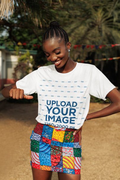 Round-Neck T-Shirt Mockup Featuring a Cheerful Woman Pointing at Her Garment