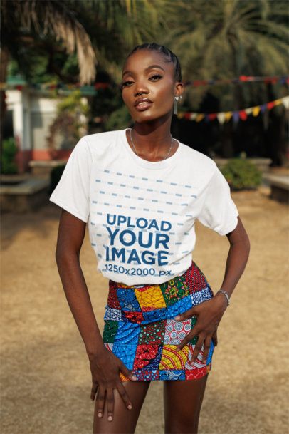 T-Shirt Mockup Featuring a Woman Posing With a Serious Look and a Colorful Outfit