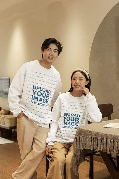 Sweatshirt Mockup Featuring a Smiling Couple Posing in a Dining Room