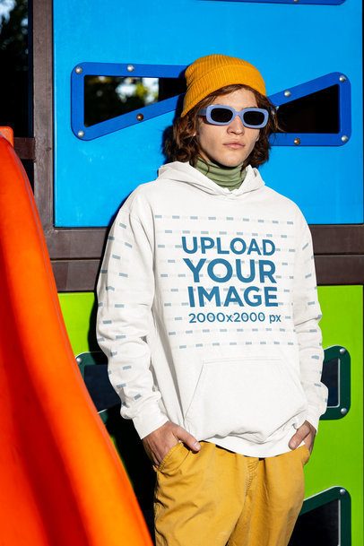 Comfort Colors Hoodie Mockup Featuring a Man Standing Against a Playground Game m53359