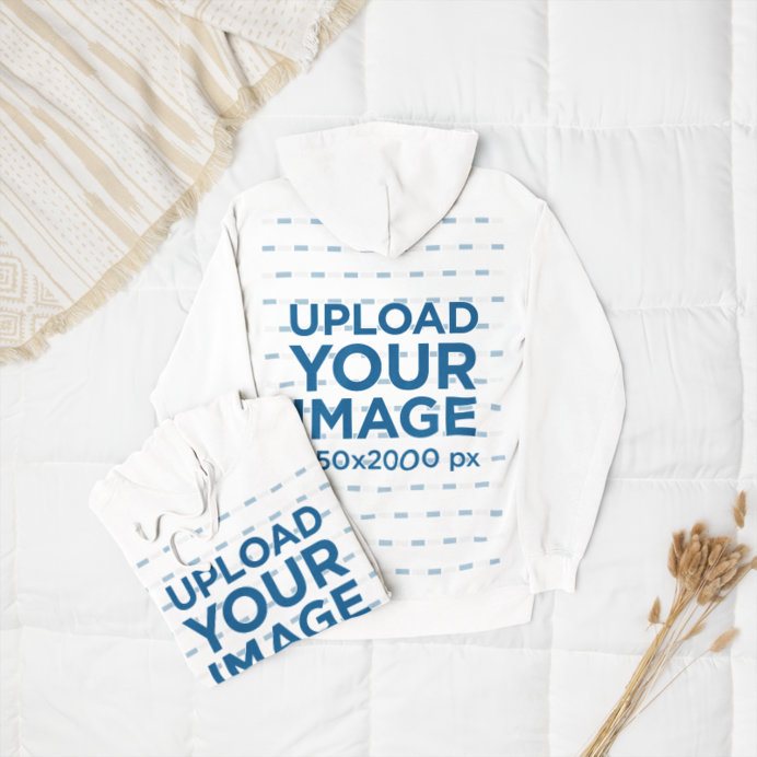 Mockup of Two Pullover Hoodies by Comfort Colors Lying on a Cozy Bed
