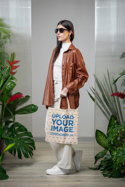 Mockup of a Woman Holding a Tote Bag in a Secret Garden-Inspired Setting m54647