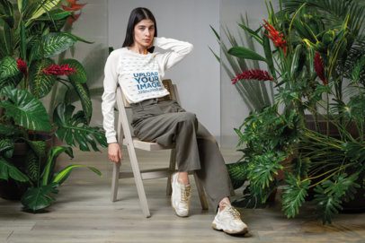 Bella Canvas Long-Sleeve Tee Mockup of a Woman Sitting in a Chair in a Secret Garden-Inspired Setting m54643
