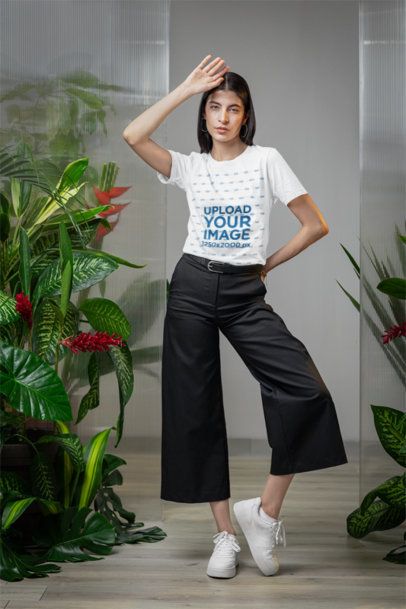 Mockup of a Woman Wearing a Bella Canvas T-Shirt in Room With Plants m54670