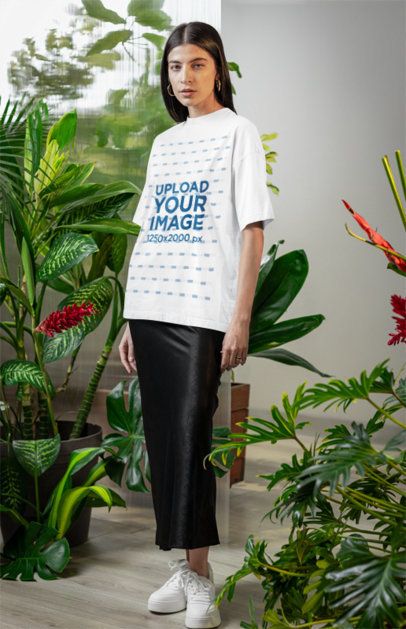 Oversized T-Shirt Mockup Featuring a Serious Woman Standing in a Secret Garden-Inspired Set m54667