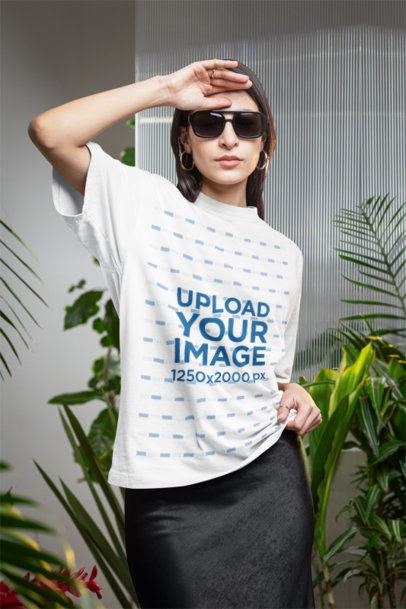 Oversized T-Shirt Mockup of a Woman With Sunglasses Posing in a Secret Garden-Inspired Setting m54668