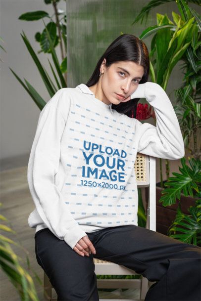 Comfort Colors Sweatshirt Mockup Featuring a Woman on a Chair With Some Plants in the Back m54646