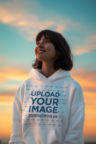 Hoodie Mockup Featuring an AI-Created Smiling Woman Posing Against a Sunset Sky