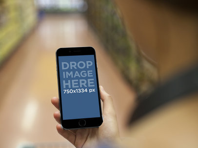 Mockup of Young Lady using Her iPhone 6 at the Supermarket
